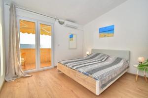 Postel nebo postele na pokoji v ubytování Apartments Bartulić