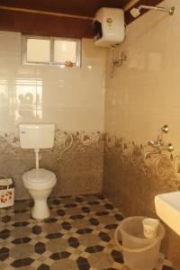 a bathroom with a toilet and a sink at Ridge View Chalet Homestay in Darjeeling