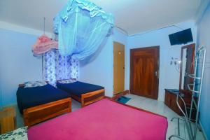 Letto o letti in una camera di Tony's Garden House Back Packers inn