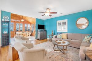a living room with blue walls and a couch and chairs at Town of Bethany Beach -- 33282 Argyle in Bethany Beach
