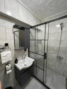 a bathroom with a sink and a shower at PANORAMA CITY SUITE in Istanbul
