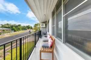 a balcony with two benches on a house at 'Botanica Paradiso' A Vibrant Nightcliff Solace in Nightcliff