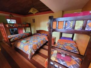 a room with two bunk beds in a house at La Minga Hostal in Salinas