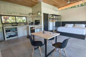 a bedroom with a bed and a table and chairs at Casa Sol y Luna, Santa Teresa in Santa Teresa Beach