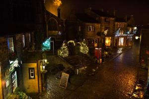 a city street with christmas lights on buildings at night at Haworth Prime Location 3 Bedroom Duplex Apartment in Haworth