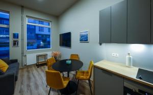 a kitchen and living room with a table and chairs at Center apartments - Hekla in Reykjavík