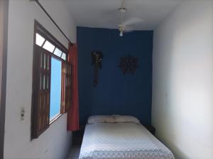 a small room with a bed and a window at O Refugio in Mata de Sao Joao