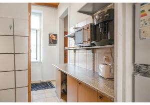 a kitchen with a counter top and a refrigerator at Welcoming 2BR Apt. Near Danube & Millenium Tower in Vienna