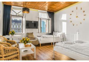 a bedroom with two beds and a living room at Welcoming 2BR Apt. Near Danube & Millenium Tower in Vienna