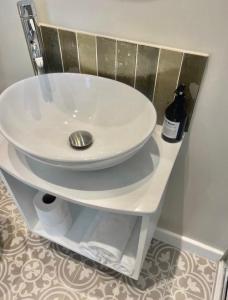 a white sink on a shelf in a bathroom at Harbour View House in St Ives
