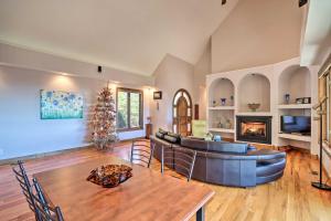 a living room with a couch and a table at Expansive Murphy Retreat with Mountain Views! in Murphy