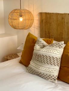 a bed with some pillows on it with at Harbour View House in St Ives