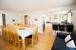 a dining room and kitchen with a table and chairs at Croyde Ocean Breeze 5 Bedrooms in Croyde