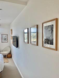 a living room with four pictures on the wall at Harbour View House in St Ives