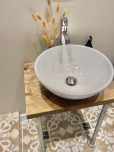 a white sink on a wooden counter in a bathroom at Harbour View House in St Ives