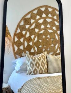 a bedroom with a bed with a wooden headboard at Harbour View House in St Ives