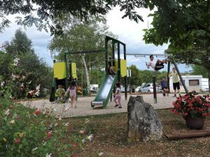 a group of children playing on a playground at Camping les Campagnes in Rocamadour