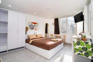 a bedroom with a bed and a television in it at Ekomo Home 102 - Central Saigon in Ho Chi Minh City