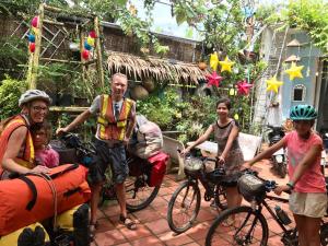 a group of people with bikes and a man and children at Green Sunshine Homestay in Can Tho