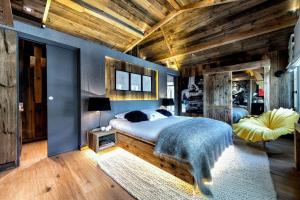 a bedroom with a bed and a blue wall at Nice view and only the rush of the river below to lull you to sleep in Visp