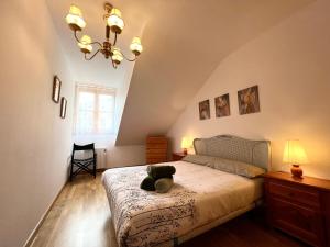 a bedroom with a bed with a stuffed animal on it at Apartamento Centrico con Parking in Rialp