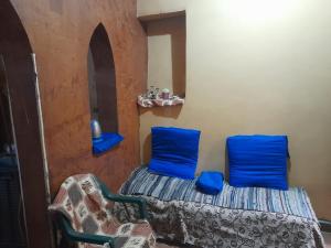 a room with two blue pillows on a bed at Elephantina sobek in Aswan
