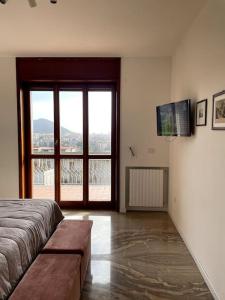 a bedroom with a bed and a sliding glass door at Verdemare, Casa & Panorama - Salerno, Amalfi Coast in Salerno