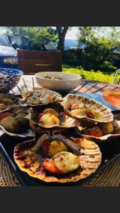 a table with several plates of seafood on it at Sunset Cabin- glass frontage luxury couples cabin. in Shieldaig