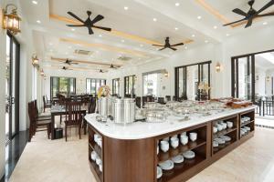 a large room with a buffet with dishes on it at DAD Resort Phú Quốc in Phú Quốc