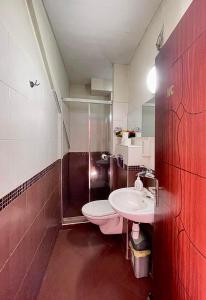 a bathroom with a toilet and a sink at Rooms Sonata in Kyustendil