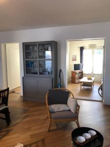 a living room with a couch and a chair at Nice 120m with garden near the sea in Sainte-Marie-de-Ré