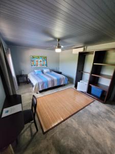 um quarto com uma cama e piso em madeira em The Inn at Punta Mala em Pedasí Town