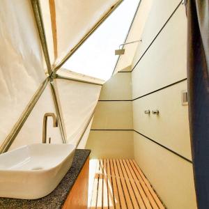 a bathroom with a sink in a tent at Mars Glam Camp in Aguascalientes