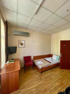 a room with a bed and a desk and a chair at Rooms Sonata in Kyustendil