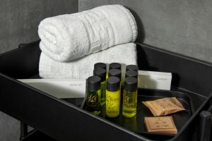 a box with three bottles of soap and towels at Urban Condo 43 - 1 Bdr in Nicosia