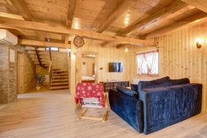 a living room with a couch and a table at Apartment Stone and Wood in Cetingrad