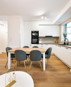 - une cuisine et une salle à manger avec une table et des chaises dans l'établissement Unique Tower 22 Floor De Luxe Apartment, à Varsovie