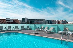a swimming pool on the roof of a building at SANA Reno Hotel in Lisbon