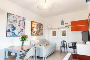 a living room with a white couch and a table at Rta la Pergola in Marina di Massa