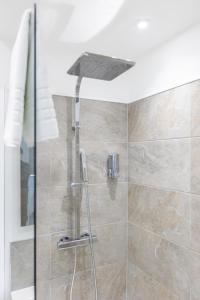 a shower with a shower head in a bathroom at Platform City Theatre Studio with Secure Parking in Hull