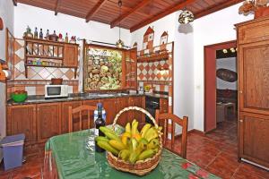 a kitchen with a table with a basket of bananas at Casa Tia Rosalia in Tijarafe