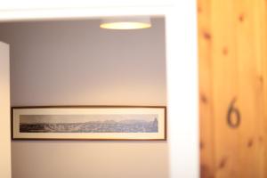 a picture hanging on a wall in a room at Tirana Experience, Authentic Stays in the Heart of Old Tirana in Tirana +37 photos