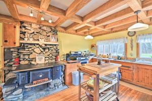 a kitchen with a stove and a stone wall at Old Time Catskill Mtn Retreat, Handcrafted Cabin! in Cornwallville