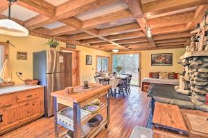 a kitchen and dining room with a refrigerator and a table at Old Time Catskill Mtn Retreat, Handcrafted Cabin! in Cornwallville +27 photos