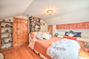 a bedroom with two beds and a stone wall at Old Time Catskill Mtn Retreat, Handcrafted Cabin! in Cornwallville