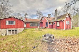 a red house sitting on top of a grass field at Old Time Catskill Mtn Retreat, Handcrafted Cabin! in Cornwallville