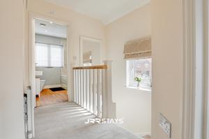 a hallway of a home with a staircase and a window at Chorley - Large 3 Bedroom Sleeps 6, Wi-Fi, Garden - JRR Stays in Leyland