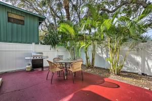 a patio with a table and chairs and a grill at Indian Rocks Beach Duplex, Close to Beaches! in Clearwater Beach