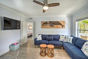 a living room with a blue couch and a ceiling fan at Indian Rocks Beach Duplex, Close to Beaches! in Clearwater Beach