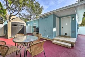 a patio with a table and chairs and a building at Indian Rocks Beach Duplex, Close to Beaches! in Clearwater Beach